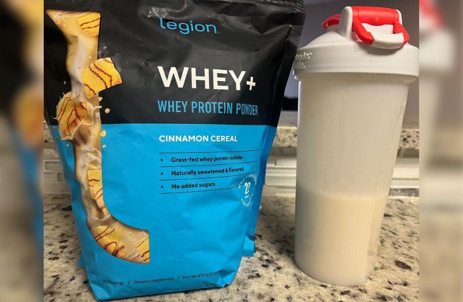 Bag of Legion Whey+ protein powder and shaker bottle