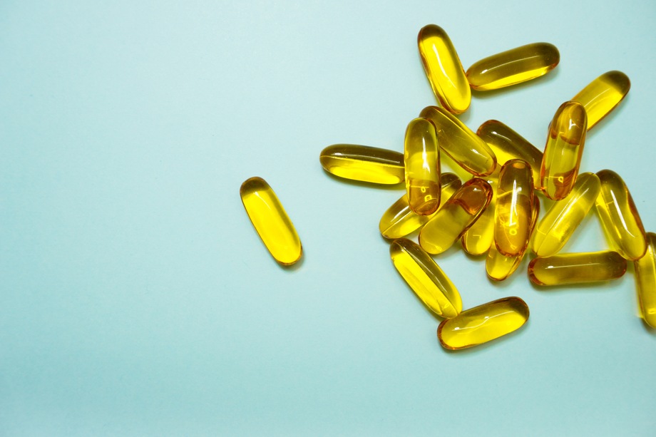 fish oil supplement on green background