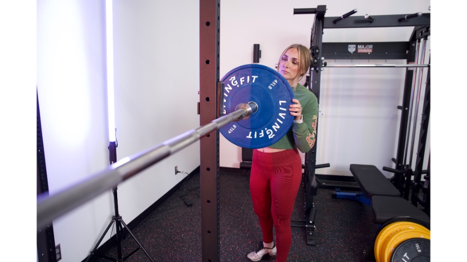 An image of a Living.Fit bumper plate on a barbell