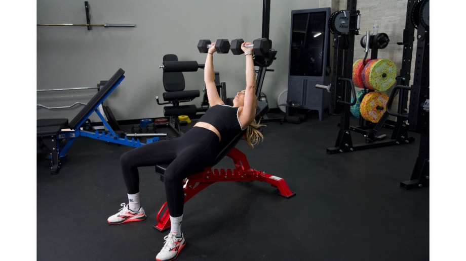 Woman performing dumbbell bench press on the Major Fitness Adjustable Bench