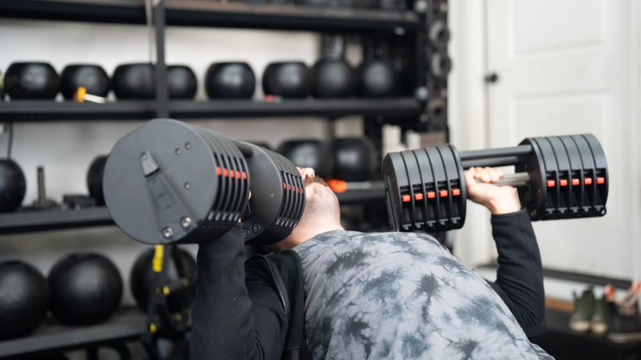 Man doing bench press with the REP Fitness QuickDraw Dumbbells