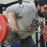 Man doing bent-over barbell rows