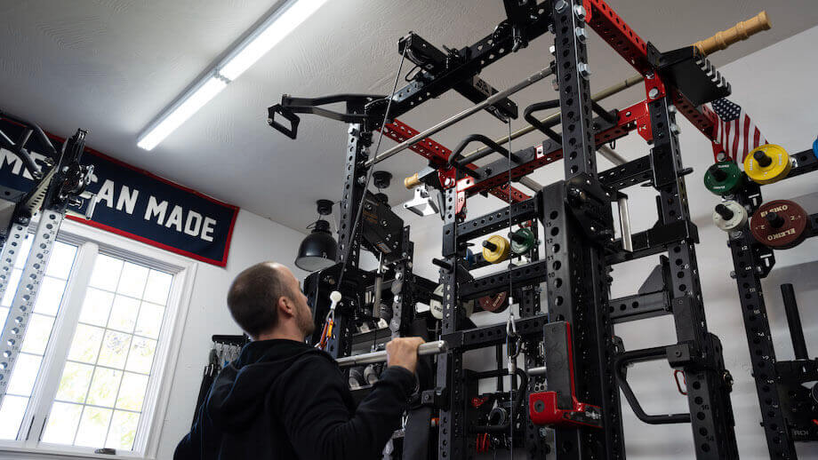 man doing lat pulldowns with the surplus strength pulley