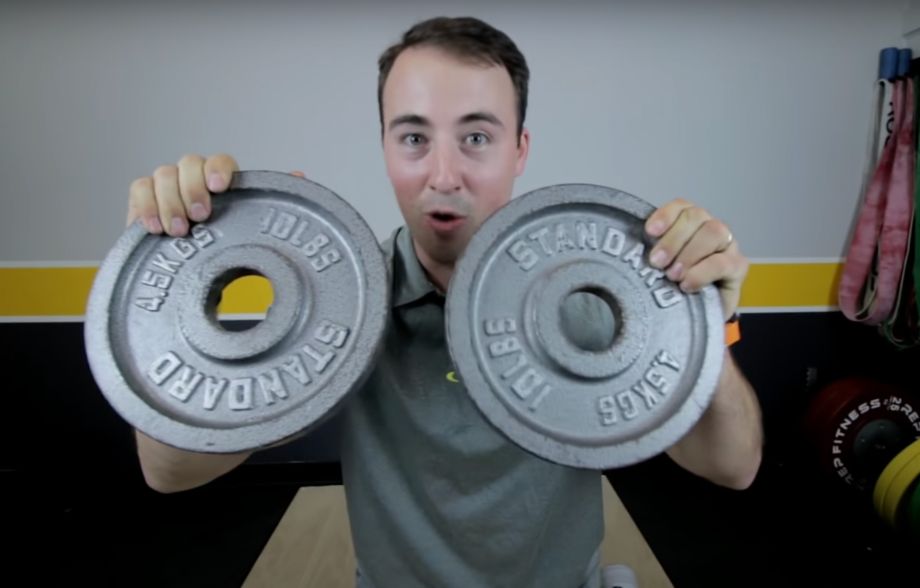 Man holding plates for DIY weight vest