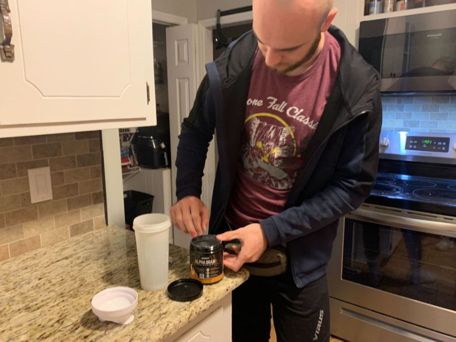 Man Opening Alpha Brain Pre Workout