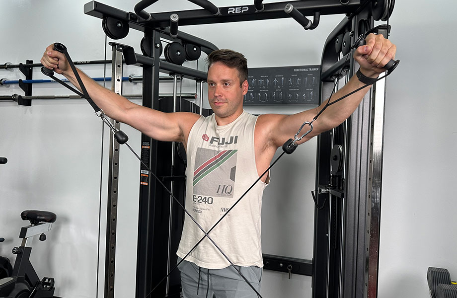 man-performing-a-delt-exercise-with-cable-crossover-machine