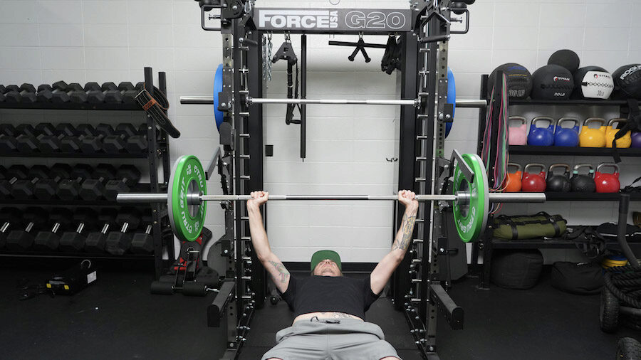 An image of a man using the Force USA G20 rack for a bench press