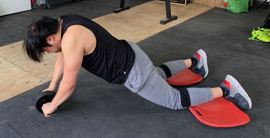 Man using REP Fitness ab roller