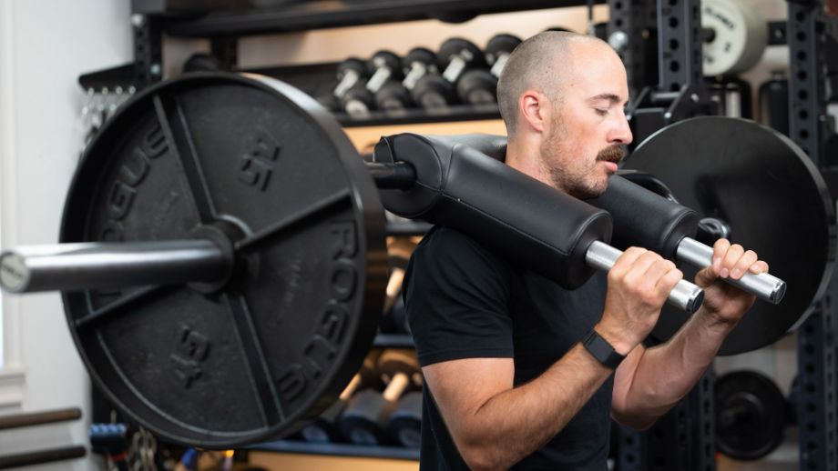 Man with the REP Fitness Safety Squat Bar on his back