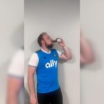man drinking a can of Slate protein