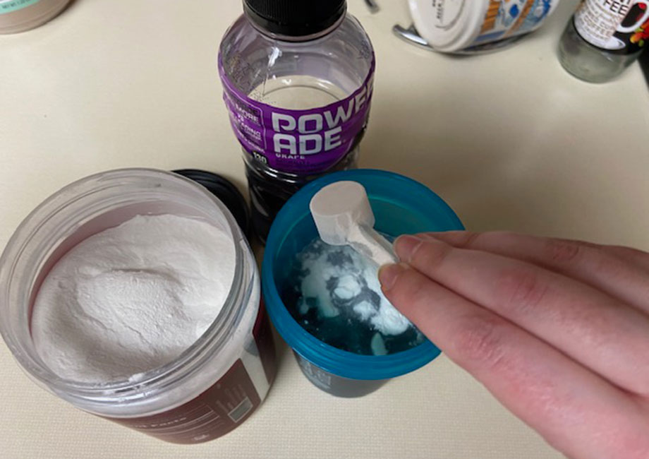 Mixing a scoop of Naked BCAAs with some PowerAde.