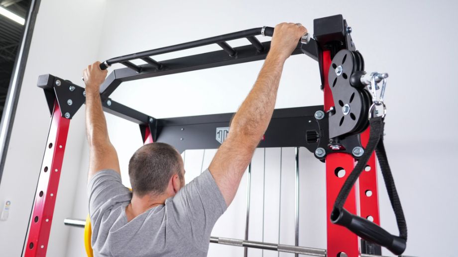 Man using the multi-grip pull-up bar on the Major Lutie Power Rack