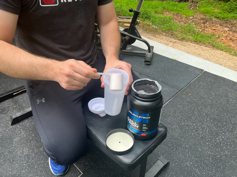 Man Putting Muscle Tech Creatine Into Shaker Cup