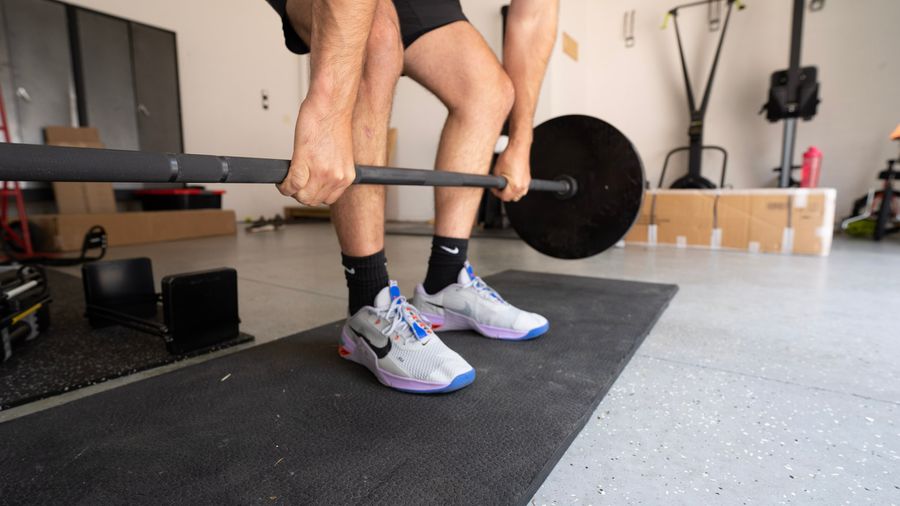 Man wearing Nike Metcon 7 cross-training shoes during deadlifts