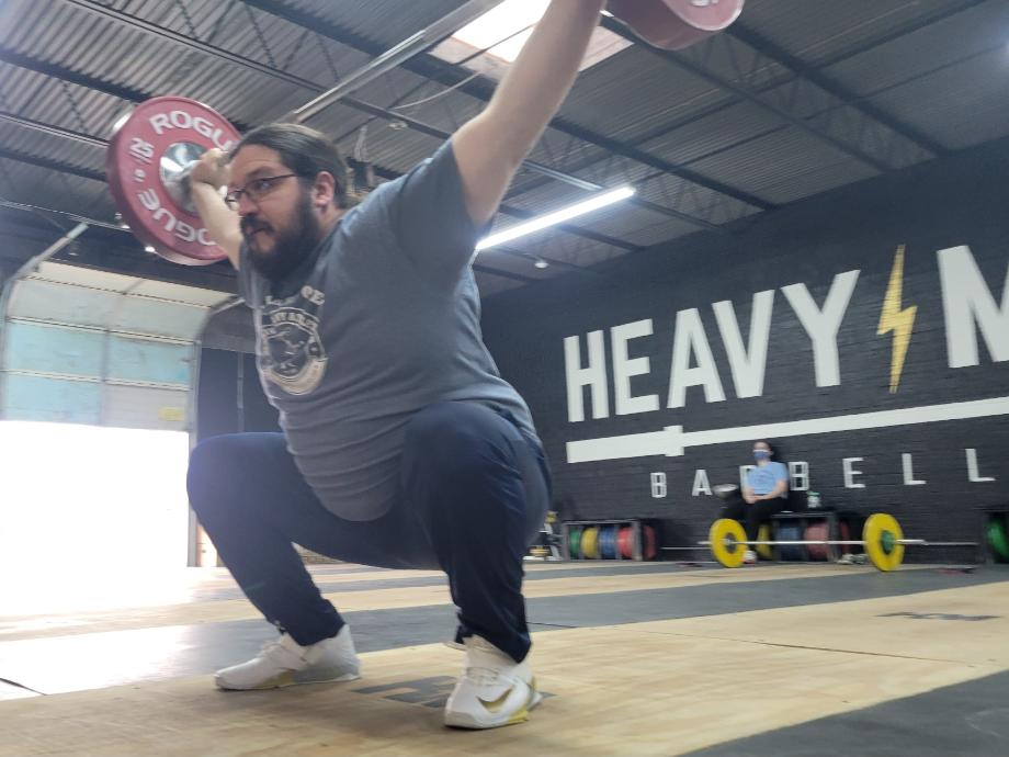 Olympian Caine Wilkes performs an overhead squat with the Nike Savaleos weightlifting shoes.