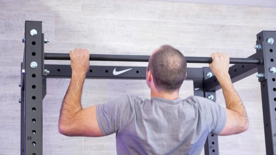 Man doing pull-ups on the Nike Squat Cage