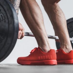 Person setting up for a deadlift in red NOBULL Trainer Plus shoe