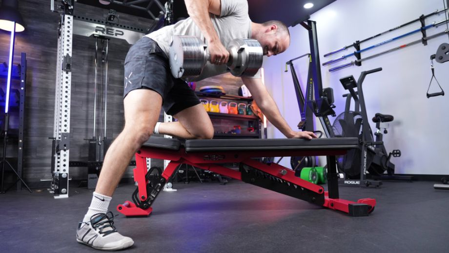 Man performing one-arm rows on the REP AB-5200 2.0