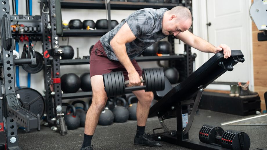 Man performing one-arm rows with the REP QuickDraw Dumbbells