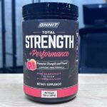 Container of Onnit Total Strength + Performance pre-workout