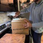 A person cuts open one of the best meat subscription boxes.