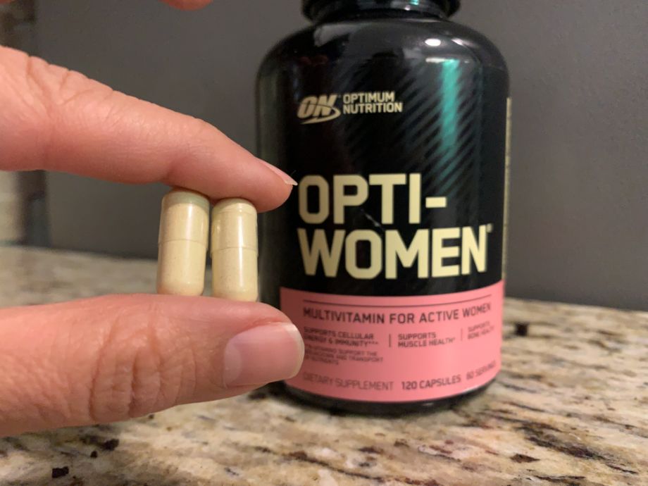 Person holding Optimum Nutrition Opti Women