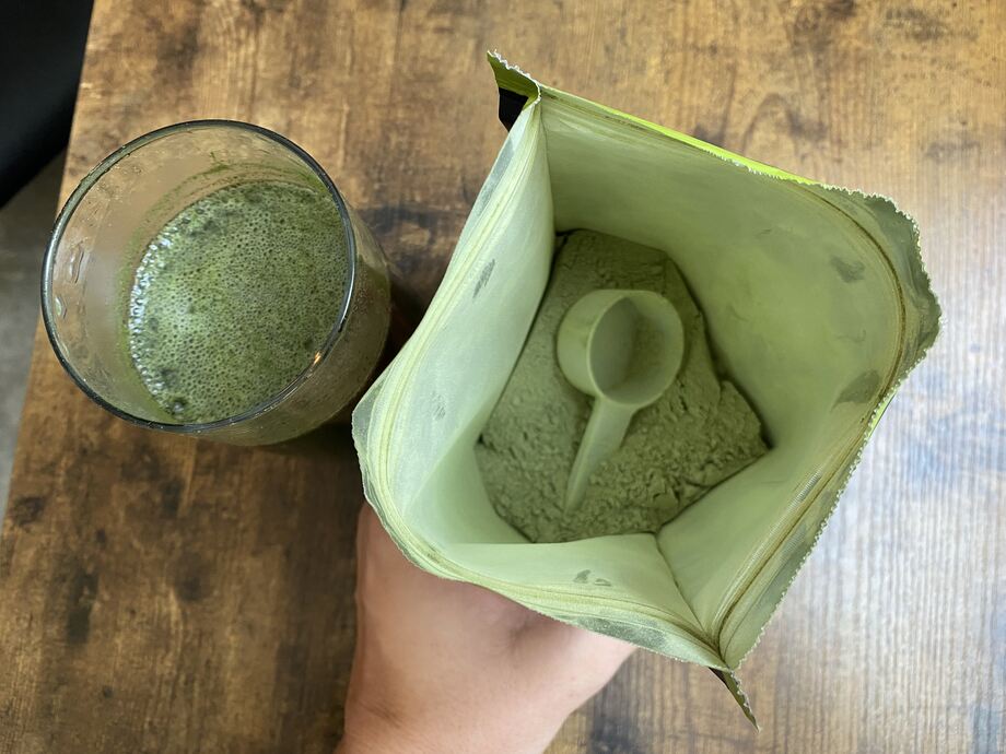 Looking down into a bag of Organifi Greens Juice powder.