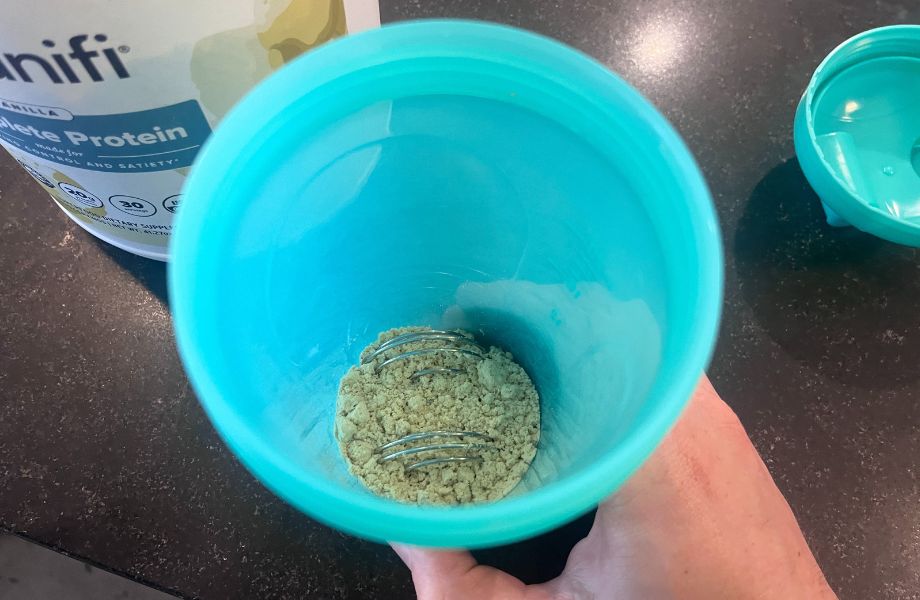 Organifi Complete Protein powder in a shaker cup