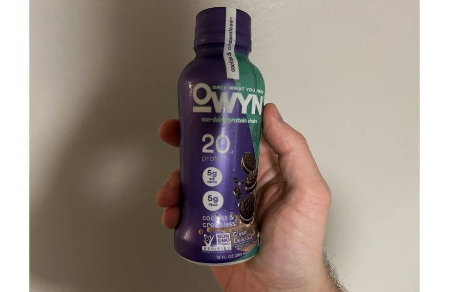 owyn protein shake bottle in hand