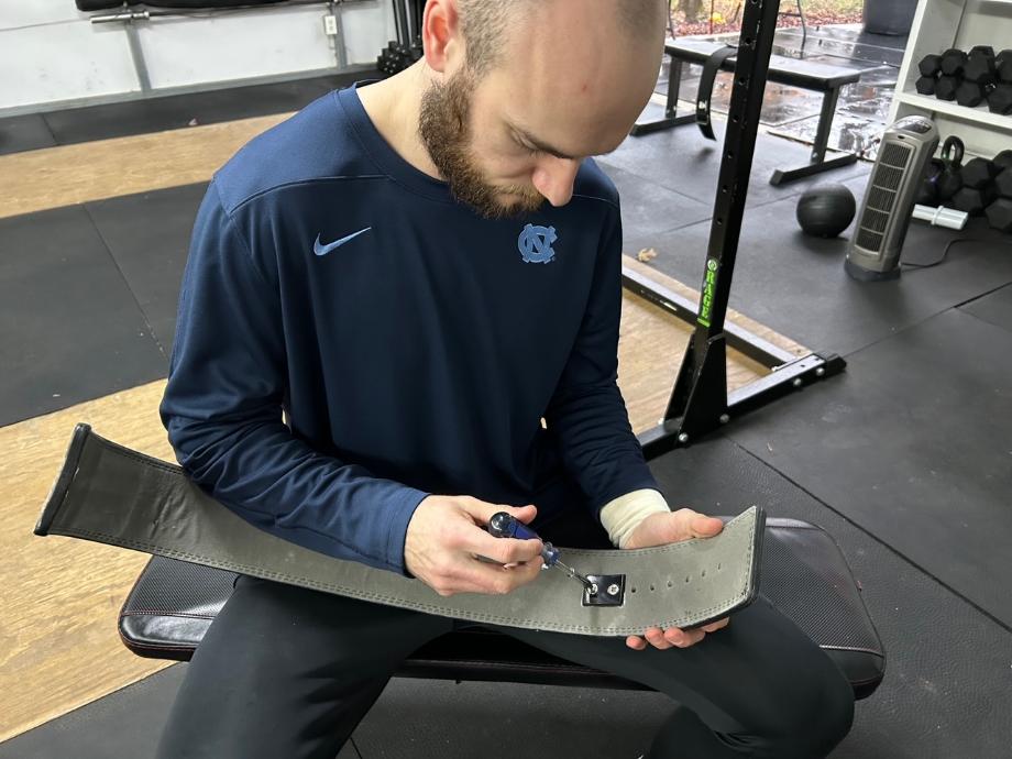 A person is shown adjusting the Gymreapers Lever Belt