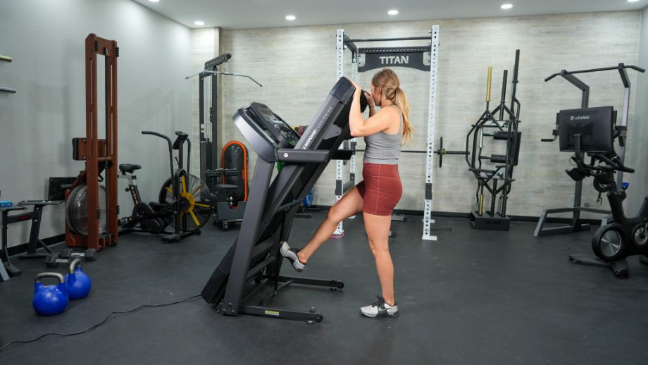 woman folding the horizon t101 treadmill