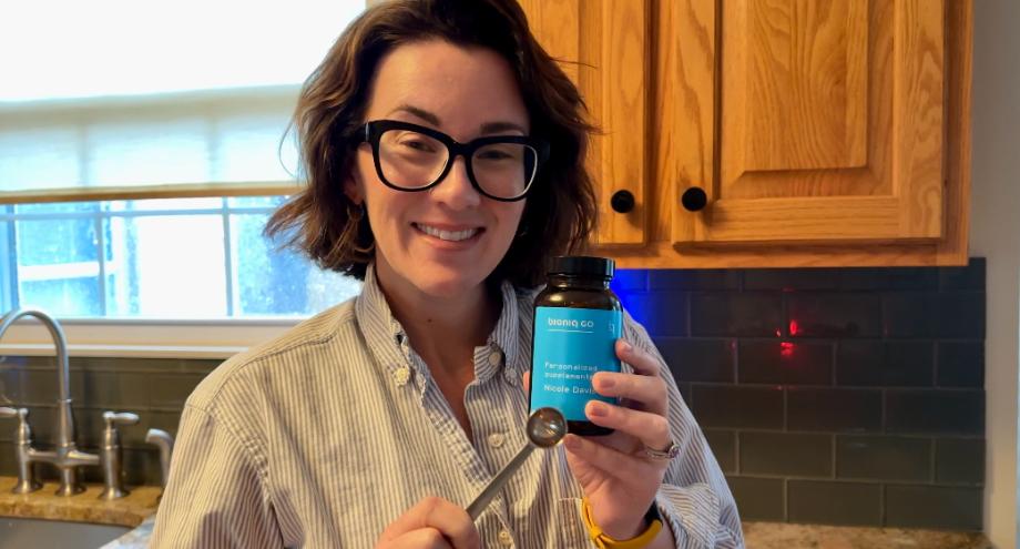 An image of a woman holding Bioniq Go multivitamin