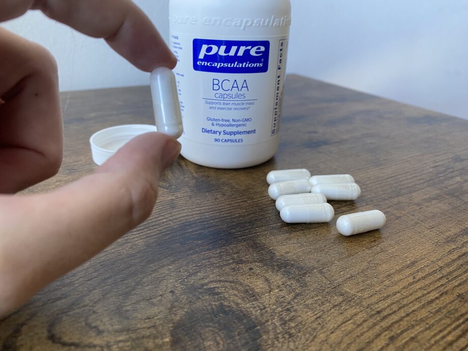 Person holding pure encapsulations bcaa capsules