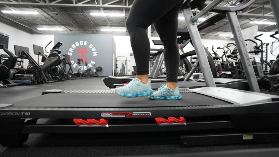 Close up shot of feet walking backward on a treadmill