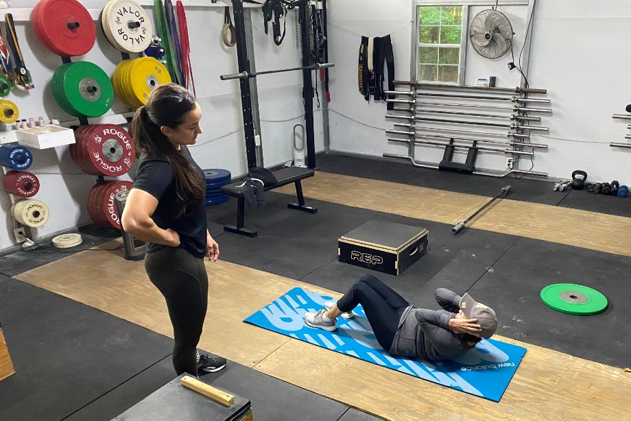 personal trainer instructing sit ups