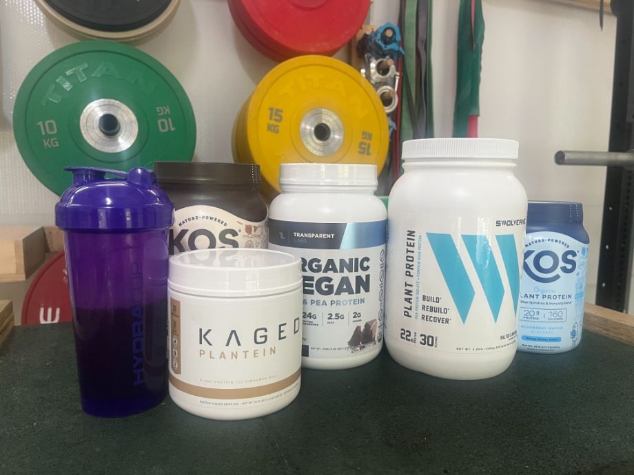 An assortment of plant and vegan protein powders in a gym