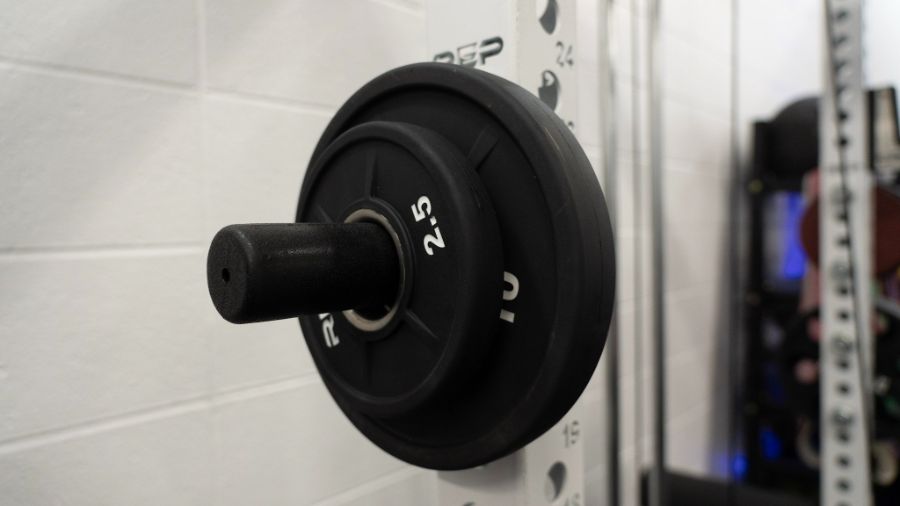 Weight plates stored on a rack attachment on a power rack
