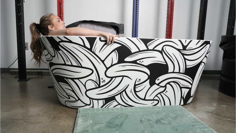 A woman with a blonde ponytail reclining in a Polar Monkeys Brain Pod 2.0 ice bath