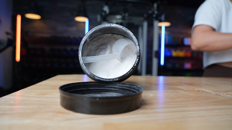 Looking deeply and meaningfully into a container of Pre-Kaged Elite, taking in the texture and grain of the supplement powder.