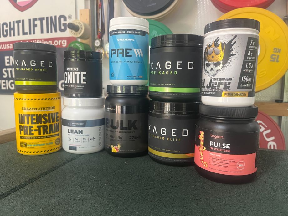 pre-workout supplements stacked in a gym