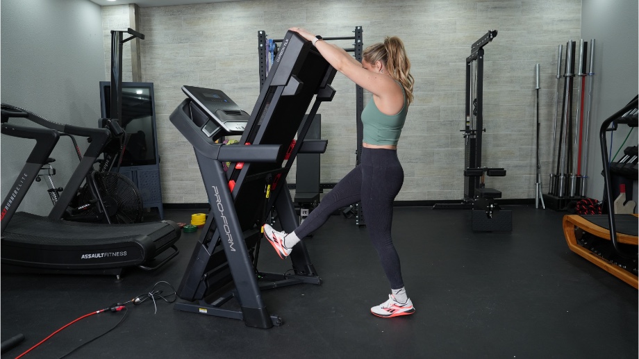 An image of a woman folding the ProForm TLX treadmill
