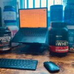 protein powders surrounding a computer