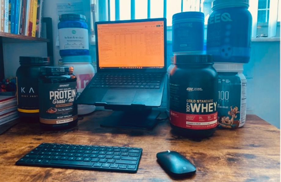 https://www.garagegymreviews.com/wp-content/uploads/protein-powders-around-computer.jpg