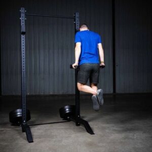 Man in blue shirt using the PRX limitless squat stand