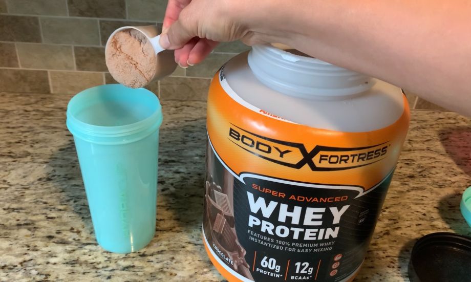 Putting Body Fortress Protein Powder In Shaker Cup