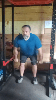 Man doing squat rack deadlifts