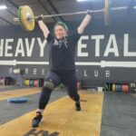 A person performs a jerk while weraing Reebok Lifter PR 3 weightlifting shoes.