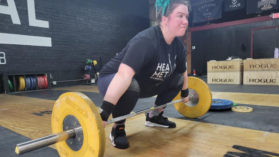 Our tester sets up for a snatch with the Reebok Lifter PR 3 weightlifting shoes.