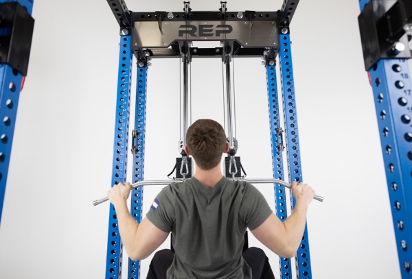 Man doing lat pulldowns with the Rep Fitness Ares Cable Attachment