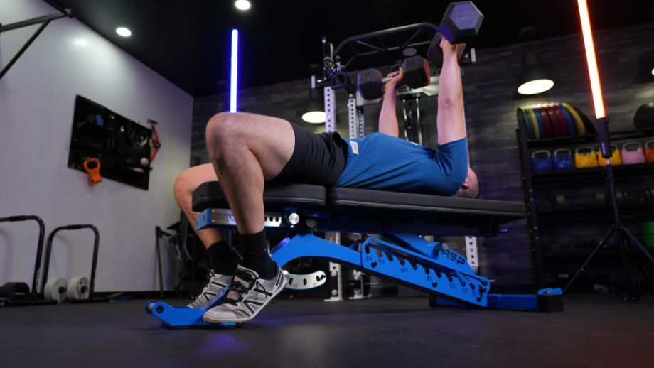 Man performing dumbbell decline bench on the REP Fitness Blackwing